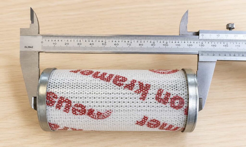 Old industrial filter element measured with caliper for custom filter dimension review