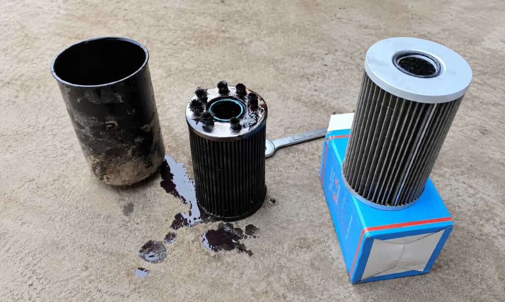 Used hydraulic filter element and new replacement filter shown for old sample review and filter matching