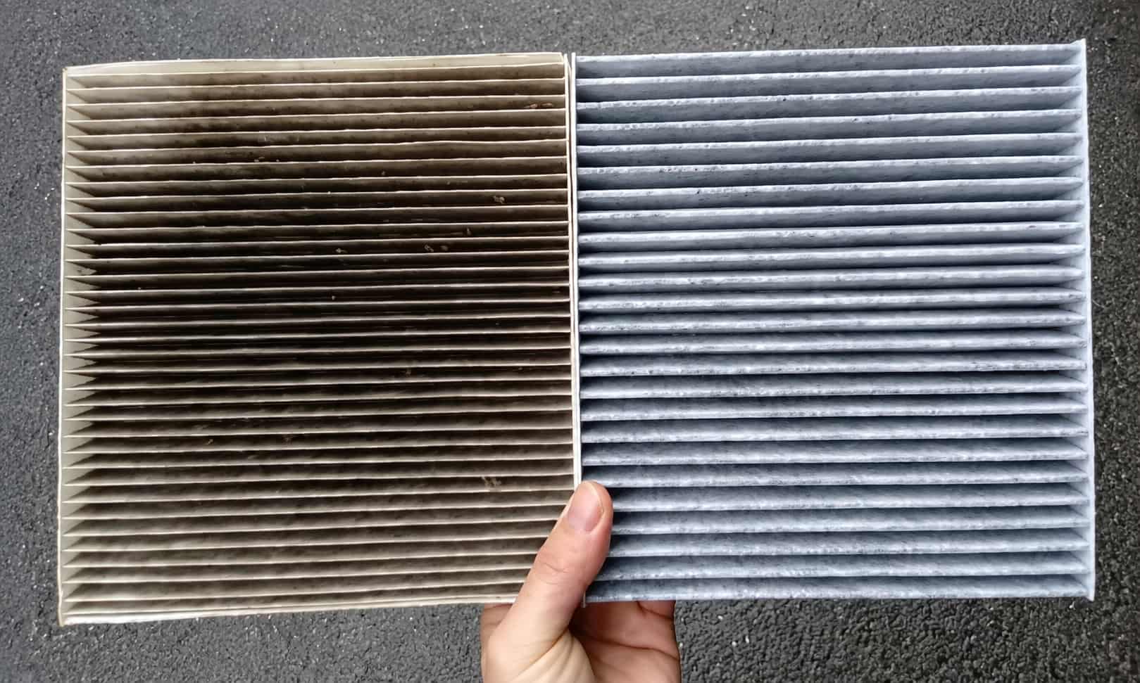 Dirty and clean cabin air filters held side by side to show dust and pollutant buildup