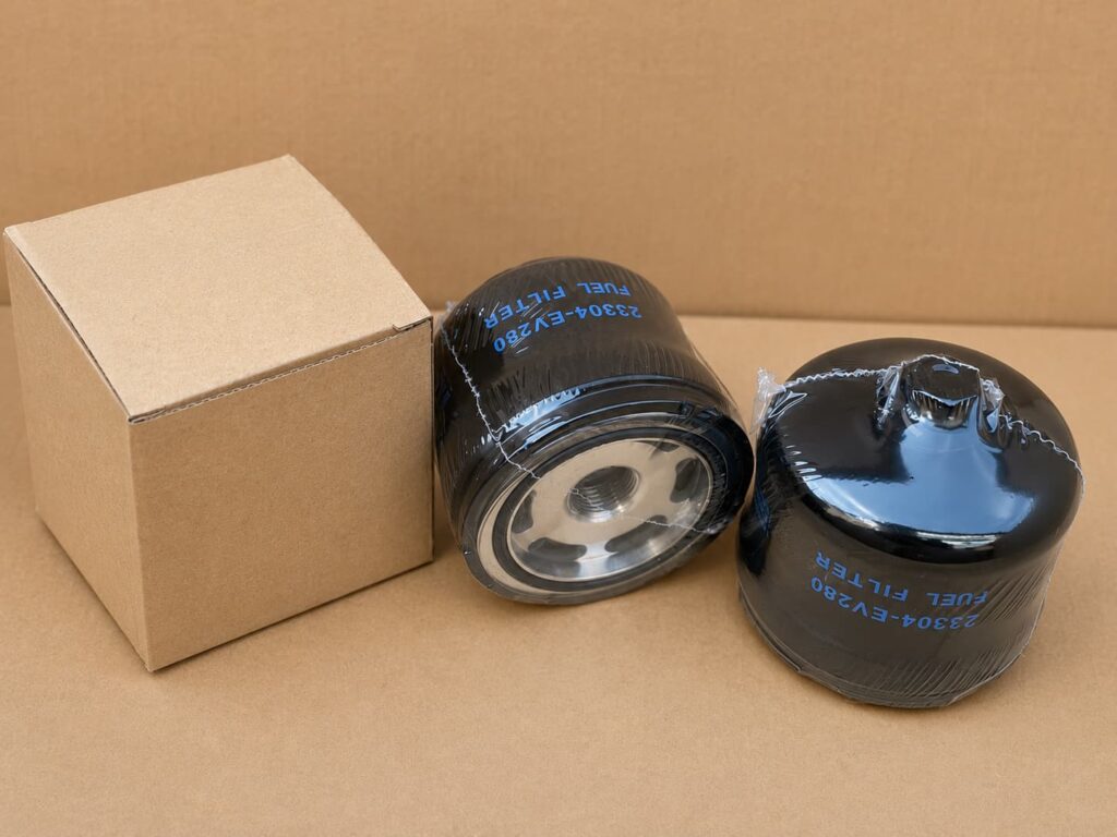 Shrink-wrapped spin-on fuel filters packed with a plain paper box for clean storage and shipment.
